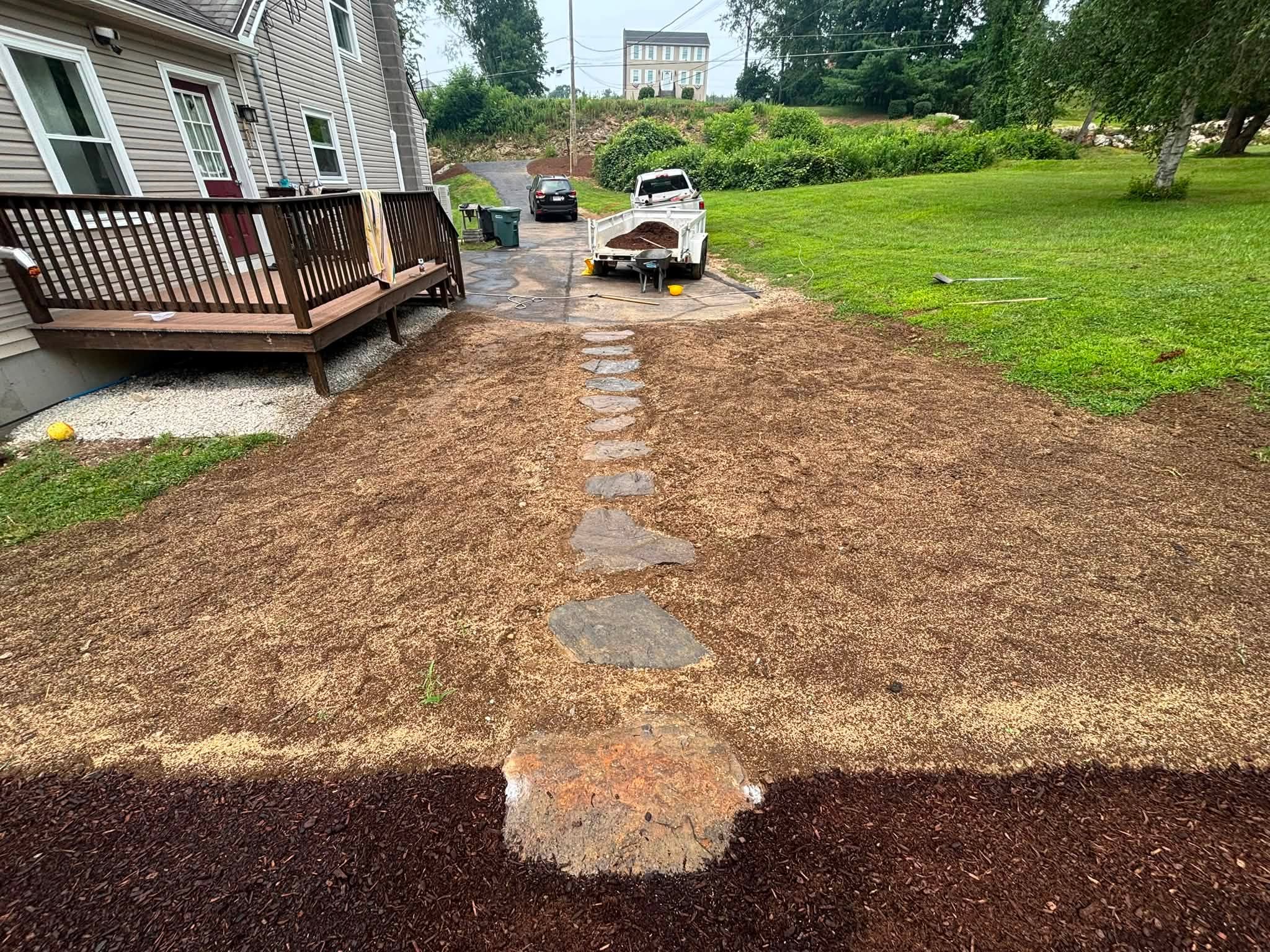 Natural stone walkway laid — drainage running correctly